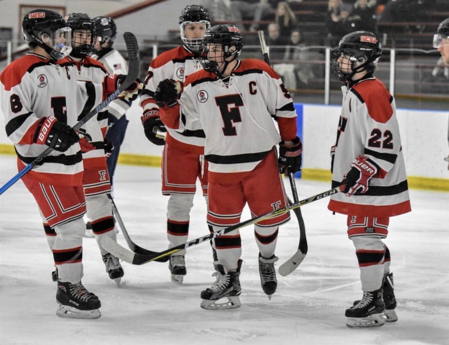 Senior captain Kevin Quinn embracing his teammates.