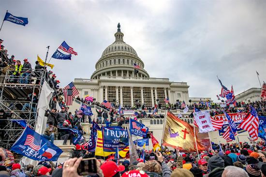 A view of the United States Capitol Building surrounded by rioters and insurrectionists on January 6, 2021